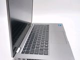 a silver laptop computer sitting on top of a white table