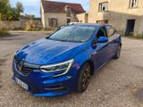the blue car is parked in front of a house