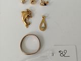 two pairs of gold rings and a gold ring on a white surface