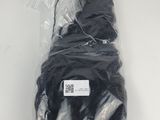 a bag of black yarn wrapped in plastic on a white surface