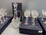 several wine glasses and a decanter are on display in a box