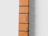 a close up of a wooden object hanging on a wall