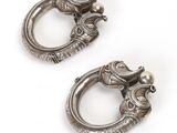 pair of antique silver metal door handles on a white background