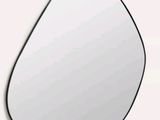 a mirror that has a tear shaped shape on it