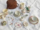a lot of tea cups and saucers sitting on a table