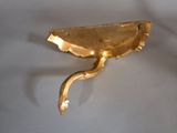 a gold plate with a handle on a wall