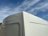 a white van that is parked on the side of the road