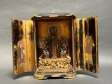 a gold and black box with a statue inside of it