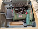 a box with a drill and other tools in it