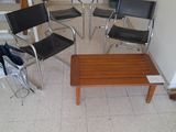 four chairs and a coffee table in a room