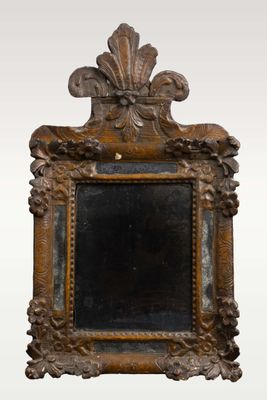 an antique mirror with a wooden frame and a decorative design