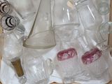many glass items in a wooden box on a table