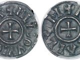 a close up of a coin with a cross on it