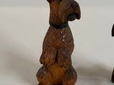 two figurines of dogs sitting next to each other