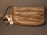 an image of a brown purse with a tag on it