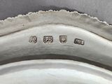 a close up of a silver plate with a name on it