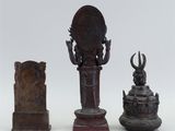 three bronze figurines of a woman and a man on a pedestal