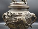 an image of a bronze incense pot with a dragon on top