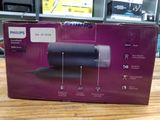 packaging of a philips hair dryer sitting on a wooden table