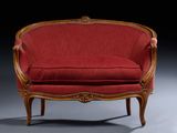 an image of a red chair with a wooden frame and a red upholstered seat