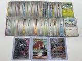 a lot of different pokemon cards on the table