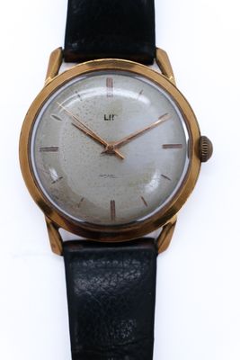 an image of a close up of a wrist watch on a white surface