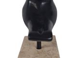statue of a black bear sitting on top of a stone block