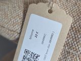 a tag on the back of a chair that has a tag attached to it