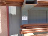 several pieces of wood are stacked on top of each other in front of a building
