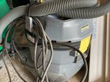 a dust collector that is sitting on the floor next to a pile of boxes