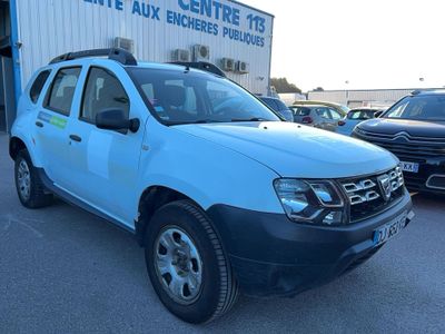 a picture of a blue dacia parked in front of a building