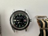 a watch that is sitting next to a watch on a table