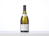 a bottle of white wine sitting on top of a table