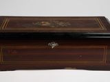 an antique wooden box with a decorative design on the lid
