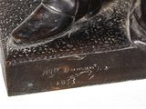 statue of a man with a cane and boots on a base