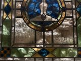 a stained glass window with a cross on it