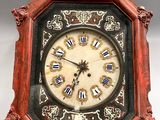 a clock that is sitting on a white surface