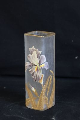 a glass vase with a flower on it on a black background