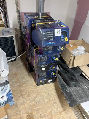 a pile of boxes sitting on the floor next to a radiator