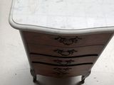 a marble top table with four drawers on it