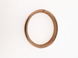 a ring on a white surface with a white wall in the background