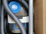 a box with a vacuum and a hose inside of it
