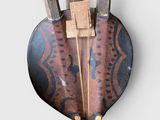 a wooden heart shaped object with three knives on it