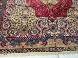 a red and yellow rug on a white floor