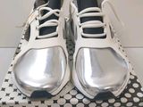 a box with a pair of silver shoes on it