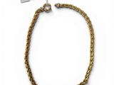 a close up of a gold chain bracelet on a white background