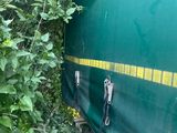 a green cover on the side of a train car