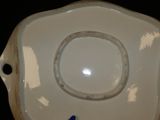 a white plate with a blue flower on it
