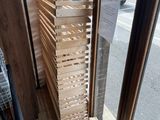 a stack of wooden crates sitting in front of a window