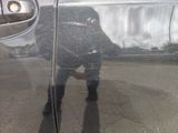 reflection of a person in a car door mirror on the side of the road